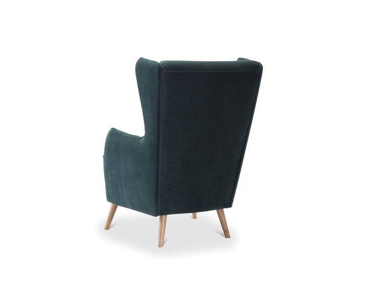 Zöld kárpitos füles fotel.