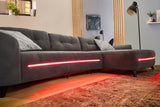 Szürke L alakú kanapé RGB világítással, hangszóróval, USB csatlakozóval.